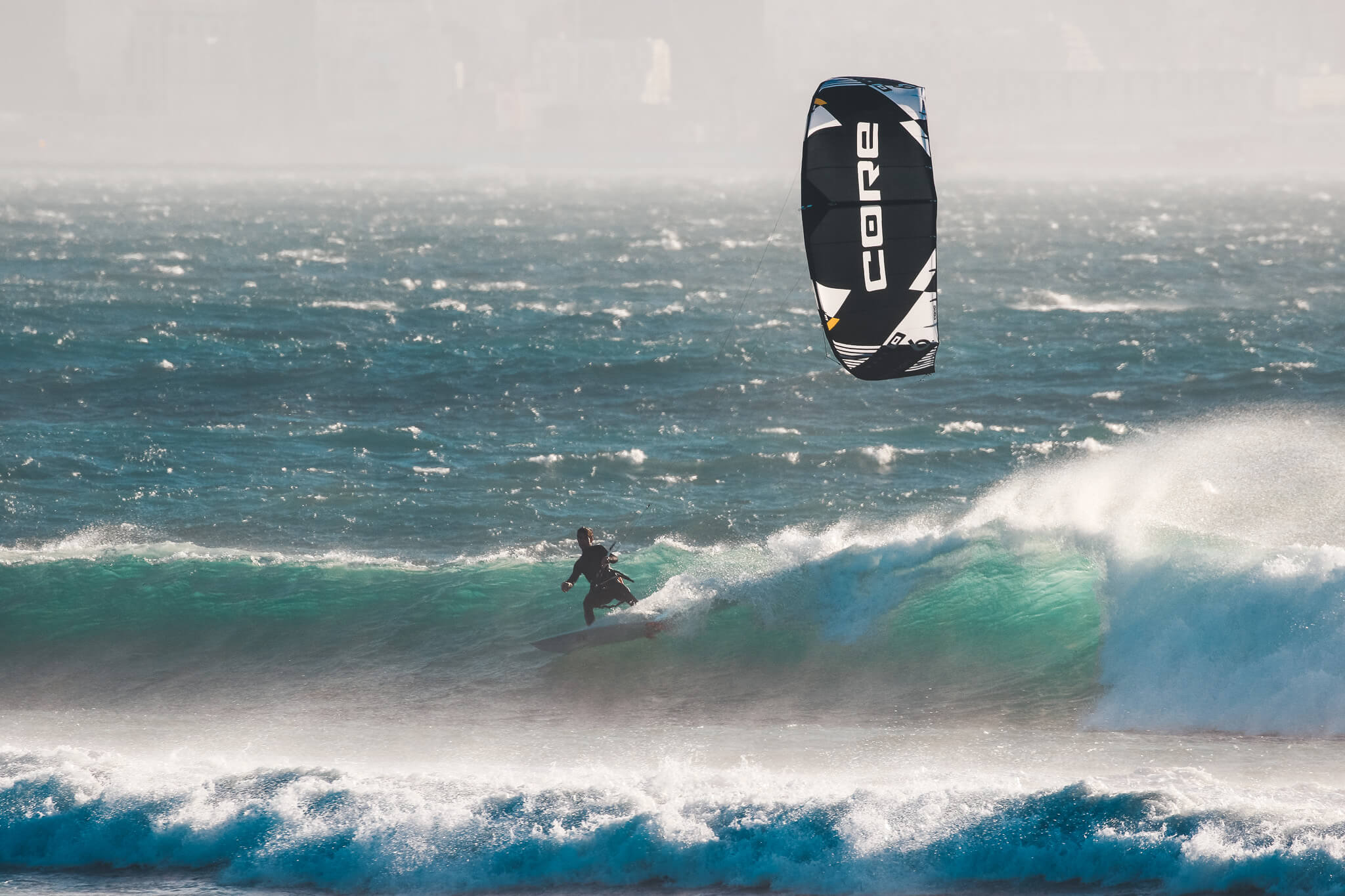 Professional kitesurfer riding waves